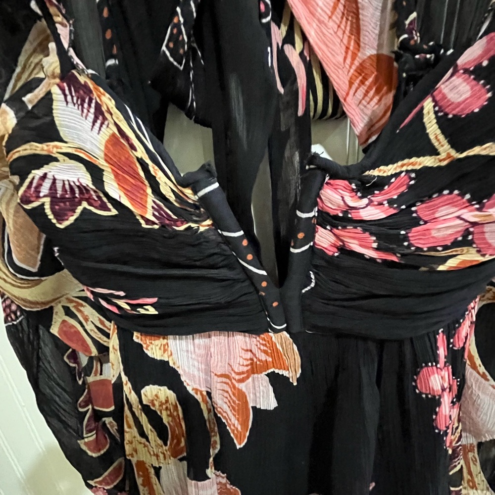 Anthropologie dress.  Black print short dress with cut out back and tie detail.